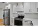 A kitchen featuring stainless steel appliances and white cabinetry with black hardware at 3565 Collier Drive Nw Rd, Atlanta, GA 30331