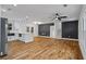 Spacious living room and kitchen area featuring hardwood floors, modern decor, and a staircase, perfect for entertaining at 3565 Collier Drive Nw Rd, Atlanta, GA 30331