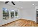 Sunlit living area features hardwood floors, large windows offering outside views, and neutral walls, creating a serene atmosphere at 3565 Collier Drive Nw Rd, Atlanta, GA 30331