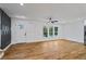 Bright, open living area featuring hardwood floors, a modern accent wall, and large windows at 3565 Collier Drive Nw Rd, Atlanta, GA 30331