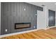 Living room featuring a modern fireplace and custom black wood paneling at 3565 Collier Drive Nw Rd, Atlanta, GA 30331