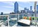 Cozy balcony with comfortable seating, colorful pillows and a breathtaking view of the city skyline at 45 Ivan Allen Jr Nw Blvd # 1908, Atlanta, GA 30308