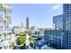 Expansive city view from high rise featuring swimming pool, modern architecture, and tree lined street at 45 Ivan Allen Jr Nw Blvd # 1908, Atlanta, GA 30308