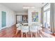 Bright dining room with wood floors, chandelier, and a table set for six with a large window at 45 Ivan Allen Jr Nw Blvd # 1908, Atlanta, GA 30308