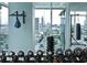 Well-equipped gym with weights, punching bags, and floor to ceiling windows overlooking the cityscape at 45 Ivan Allen Jr Nw Blvd # 1908, Atlanta, GA 30308