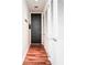 Functional hallway with wood flooring, black doors, and plenty of storage with white louvered closet doors at 45 Ivan Allen Jr Nw Blvd # 1908, Atlanta, GA 30308