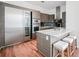 Sleek modern kitchen with stainless steel appliances, a center island with seating, and stylish wood cabinetry at 45 Ivan Allen Jr Nw Blvd # 1908, Atlanta, GA 30308