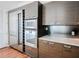 Modern kitchen with stainless steel appliances, a wine cooler, and sleek, dark wood cabinets at 45 Ivan Allen Jr Nw Blvd # 1908, Atlanta, GA 30308