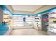 Bright spa storefront with illuminated shelving showcasing skincare products, and a blue and white modern decor at 45 Ivan Allen Jr Nw Blvd # 1908, Atlanta, GA 30308