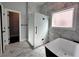 Luxurious bathroom boasts marble-look tile, glass shower, and a sleek black and white soaking tub at 958 Joseph E Boone Nw Blvd, Atlanta, GA 30314