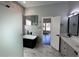 Modern bathroom featuring a black soaking tub, walk-in shower, marble tile, and sleek fixtures at 958 Joseph E Boone Nw Blvd, Atlanta, GA 30314