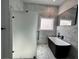 Modern bathroom featuring a black soaking tub, walk-in shower, marble tile, and sleek fixtures at 958 Joseph E Boone Nw Blvd, Atlanta, GA 30314