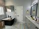 This bathroom has a stylish modern tub, double sink vanity, and marbled floors at 958 Joseph E Boone Nw Blvd, Atlanta, GA 30314