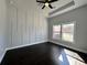 Bright bedroom features a tray ceiling with fan and a modern accent wall over hardwood floors at 958 Joseph E Boone Nw Blvd, Atlanta, GA 30314