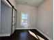 Bright bedroom featuring modern sliding doors, a window, and hardwood floors at 958 Joseph E Boone Nw Blvd, Atlanta, GA 30314