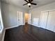 Bedroom featuring wood floors, gray walls, ceiling fan, and two closets at 958 Joseph E Boone Nw Blvd, Atlanta, GA 30314