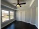 A well-lit bedroom with tray ceiling, wood floors, ceiling fan and closet at 958 Joseph E Boone Nw Blvd, Atlanta, GA 30314