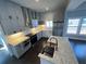 A modern kitchen featuring an island, gray cabinets, stainless steel appliances, and tile backsplash at 958 Joseph E Boone Nw Blvd, Atlanta, GA 30314