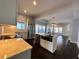 Open-concept kitchen with stainless appliances, a marble countertop island, and seamless flow into the living area at 958 Joseph E Boone Nw Blvd, Atlanta, GA 30314