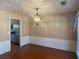 Elegant dining room featuring decorative ceiling, chandelier, and access to the updated kitchen at 615 Arncliffe Ct, Alpharetta, GA 30005