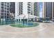 Community basketball court in a fenced outdoor recreation area with seating and city views at 1280 W Peachtree Nw St # 3303, Atlanta, GA 30309