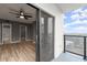 Bedroom featuring an open sliding door to a balcony, ceiling fan, and an en suite bathroom at 1280 W Peachtree Nw St # 3303, Atlanta, GA 30309