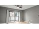 A light-filled bedroom showcasing a glass door leading to a balcony with a light gray color scheme at 1280 W Peachtree Nw St # 3303, Atlanta, GA 30309