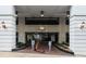 View of the 1280 West building entrance with decorative lighting and a brick-paved walkway at 1280 W Peachtree Nw St # 3303, Atlanta, GA 30309
