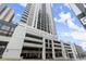 Exterior view of a high-rise apartment building in the city with parking garage at 1280 W Peachtree Nw St # 3303, Atlanta, GA 30309