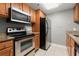 This well-appointed kitchen featuring stainless steel appliances and granite countertops at 1280 W Peachtree Nw St # 3303, Atlanta, GA 30309