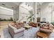 A spacious lobby area featuring comfortable seating, plants, and skylights for natural lighting at 1280 W Peachtree Nw St # 3303, Atlanta, GA 30309