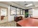 Well-lit office space with a work desk, chair, and large windows overlooking exterior landscape and a building at 1280 W Peachtree Nw St # 3303, Atlanta, GA 30309