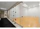 View of the community squash court with glass walls, wood flooring, and hallway access at 1280 W Peachtree Nw St # 3303, Atlanta, GA 30309