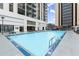 An outdoor swimming pool surrounded by lounge seating, adjacent to a building at 1280 W Peachtree Nw St # 3303, Atlanta, GA 30309