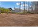 Spacious backyard with a covered patio and lush lawn, showcasing the property's serene outdoor space and landscaping at 1366 Kings Park Nw Dr, Kennesaw, GA 30152