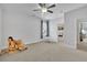 Spacious bedroom with a teddy bear, rocking horse, and view of the bathroom at 1366 Kings Park Nw Dr, Kennesaw, GA 30152