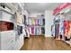Walk-in closet with custom shelving, drawers, and hanging rods for organized storage at 1366 Kings Park Nw Dr, Kennesaw, GA 30152