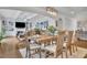 Dining area with hardwood floors, chandelier, access to living room with fireplace, and stylish decor at 1366 Kings Park Nw Dr, Kennesaw, GA 30152