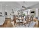 Dining area with hardwood floors, chandelier, and view to the living room with stone fireplace at 1366 Kings Park Nw Dr, Kennesaw, GA 30152