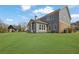 Large backyard featuring a covered outdoor seating area and beautiful home exterior at 1366 Kings Park Nw Dr, Kennesaw, GA 30152