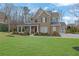 Attractive two-story home with a brick facade, columns, and a lush front yard at 1366 Kings Park Nw Dr, Kennesaw, GA 30152