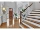 Elegant foyer featuring hardwood floors, staircase, and a front door with decorative glass at 1366 Kings Park Nw Dr, Kennesaw, GA 30152
