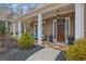 Inviting front porch with seating, lush greenery, and a welcoming entrance at 1366 Kings Park Nw Dr, Kennesaw, GA 30152
