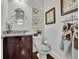 The half bath features a granite counter and framed butterfly artwork at 1366 Kings Park Nw Dr, Kennesaw, GA 30152