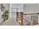 Upstairs hallway with wood railing and stairs, overlooking a sunny backyard at 1366 Kings Park Nw Dr, Kennesaw, GA 30152
