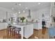 Bright, modern kitchen with white cabinets, granite countertops, and a center island with seating at 1366 Kings Park Nw Dr, Kennesaw, GA 30152