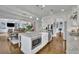 Open-concept kitchen features granite countertops, stainless steel appliances, and a large island with a microwave at 1366 Kings Park Nw Dr, Kennesaw, GA 30152