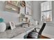 Bright office with a granite countertop desk, built-in shelving, and natural light from the window at 1366 Kings Park Nw Dr, Kennesaw, GA 30152