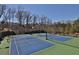 Community tennis courts for recreation and exercise in a wooded surrounding at 1366 Kings Park Nw Dr, Kennesaw, GA 30152