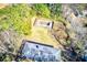 Aerial view showcasing the home's roof and a rectangular area in the backyard, framed by trees at 1650 Seayes Sw Rd, Mableton, GA 30126